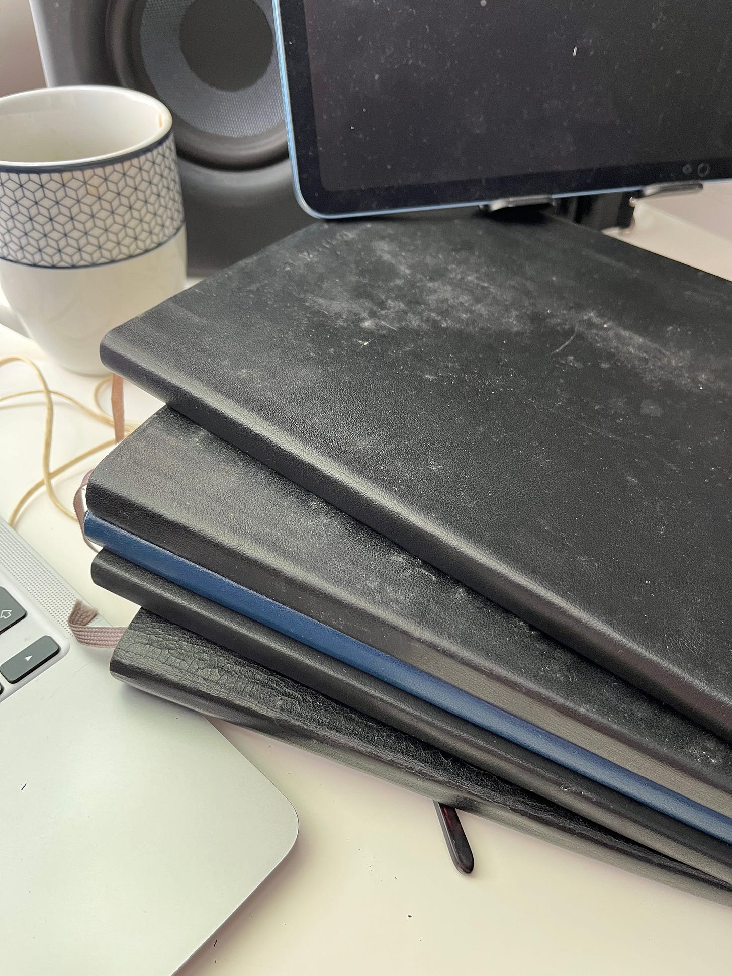 A random Moleskine journal pulled from the stack, opened to a 2016 entry on celebrating daily wins